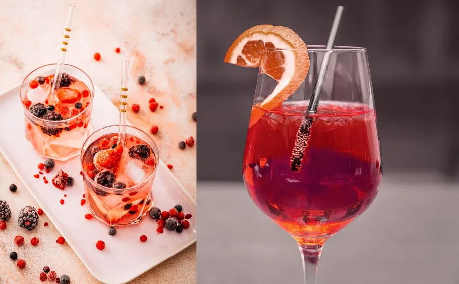 Cocktails mit Beeren und Orangendekoration.
