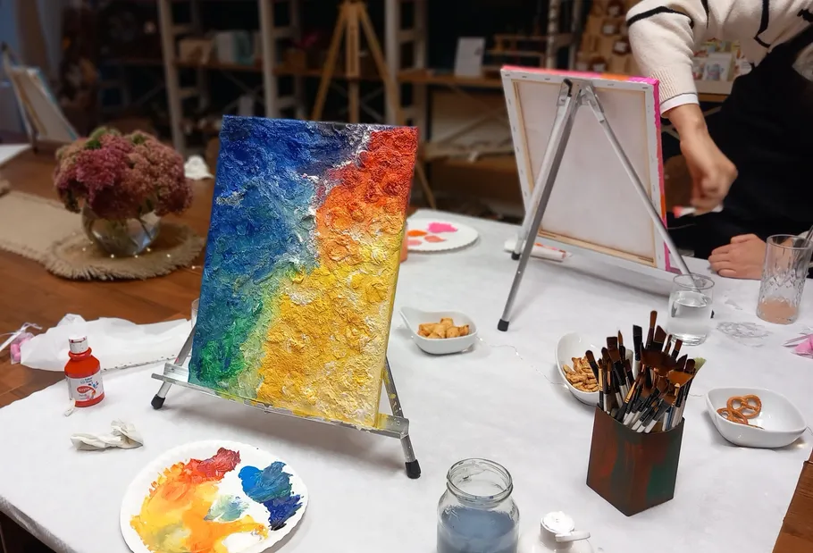 Colorful painting on easel in art class.
