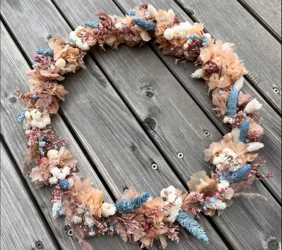 Floral wreath on wooden surface.