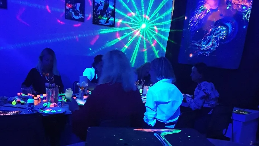 People painting in a glowing art room.