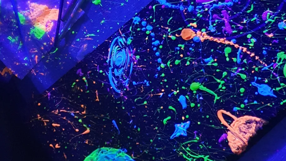Colorful abstract painting under blacklight.
