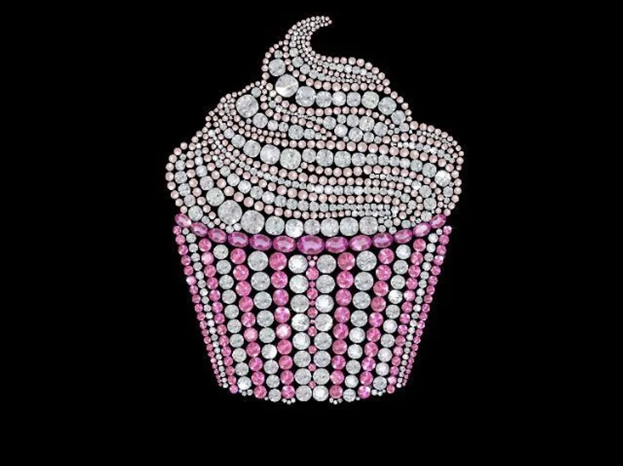 Cupcake made of rhinestones on black background.
