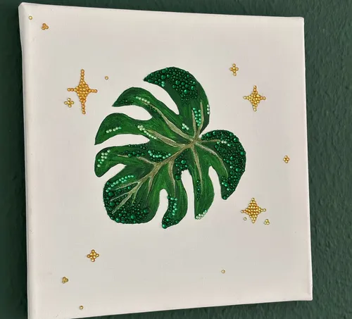 Leinwandkunst eines geschmückten Monstera-Blatts.