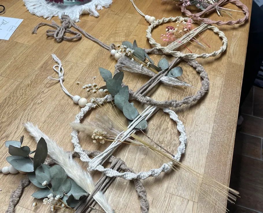 Decorative wreaths with leaves on wooden table.