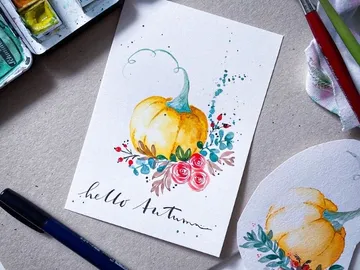 Yellow pumpkin drawing on paper with floral elements.