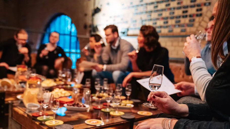 People tasting beverages in a cozy setting.