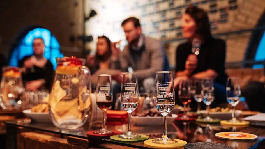Glasses on table with people in background.