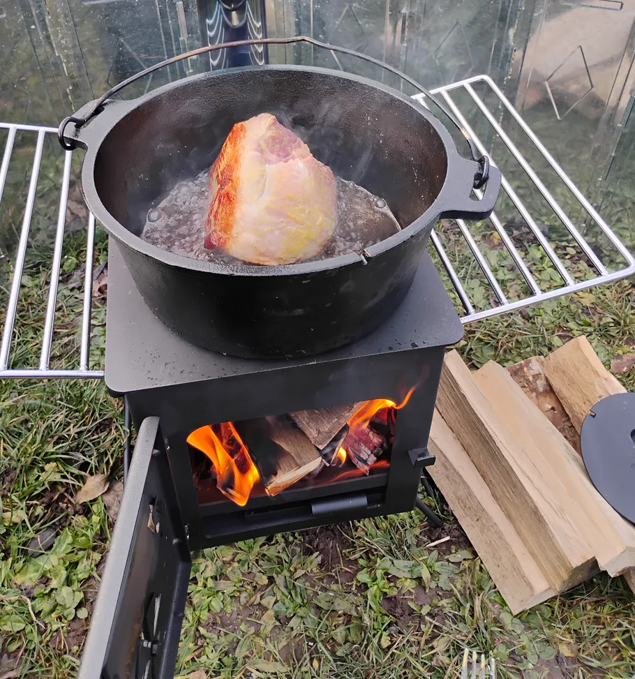 Pot roast cooking on outdoor stove.