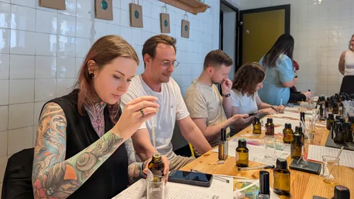People mixing perfumes in a workshop setting.