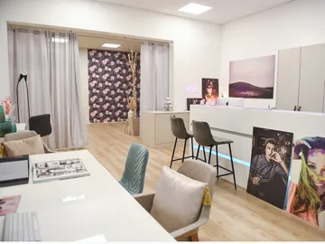 Contemporary interiors with chairs, tables and decorative paintings.