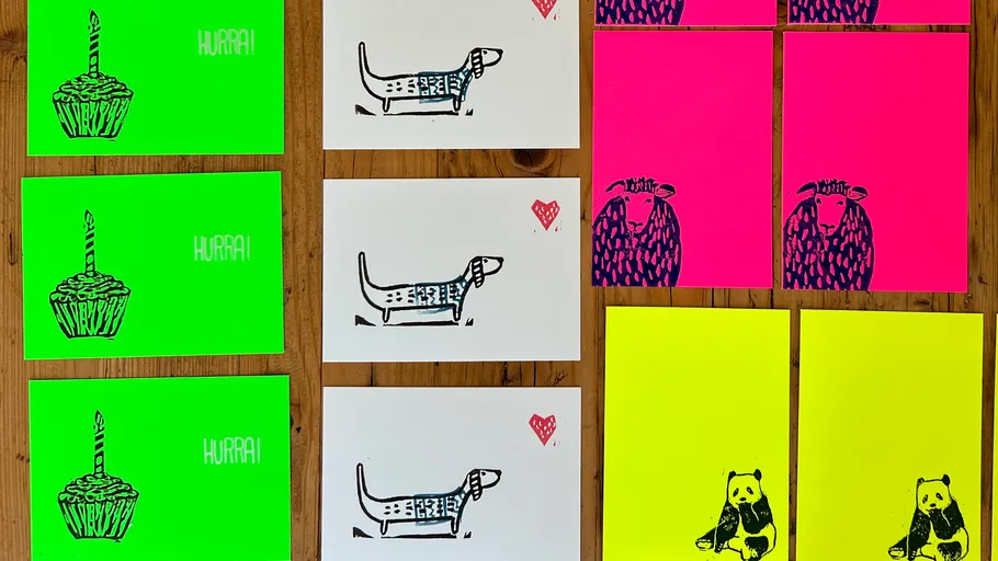Colorful printed cards with animals and cupcakes.