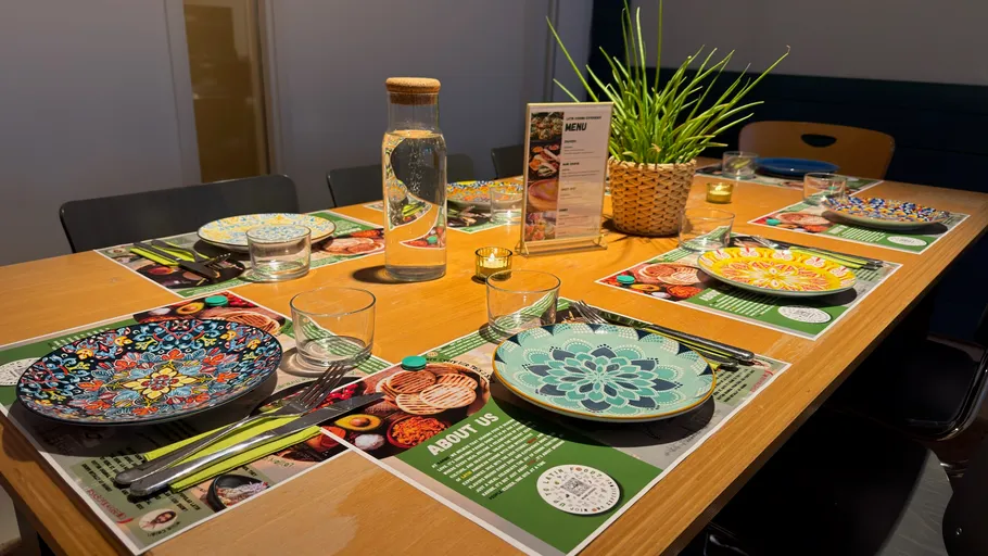 Decorative plates on wooden table with menu.
