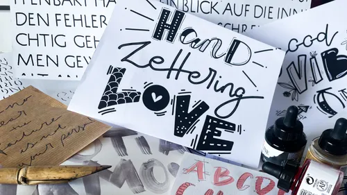 Creative hand lettering designs with calligraphy tools.