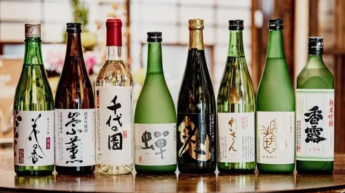 Assorted sake bottles lined on a table.