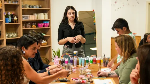 Woman instructs group in craft activity room.