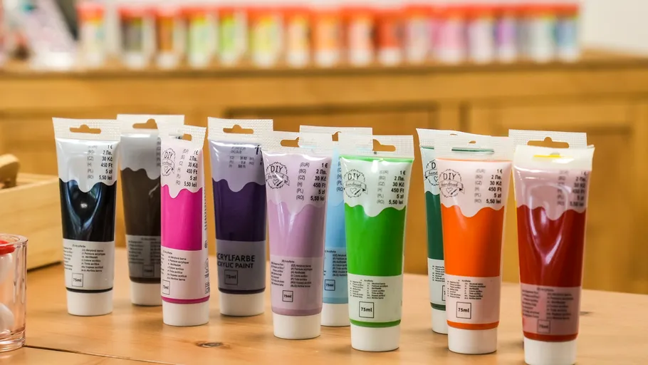 Acrylic paint tubes on a wooden table.