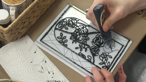 Person drawing stained glass design.