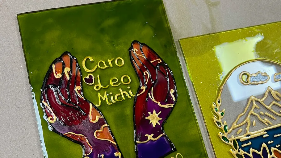 Colorful hands art on green background.