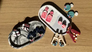 Colorful handmade earrings on wooden surface.