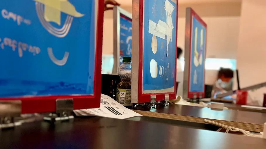 Blue screens on a table for printing.