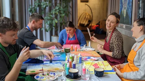 People painting at a table indoors.