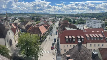 Aerial view of a town with church and road.