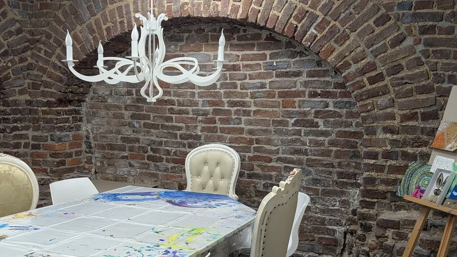 Dining table in rustic brick room.