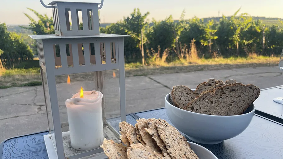Lantern and bread on outdoor table.