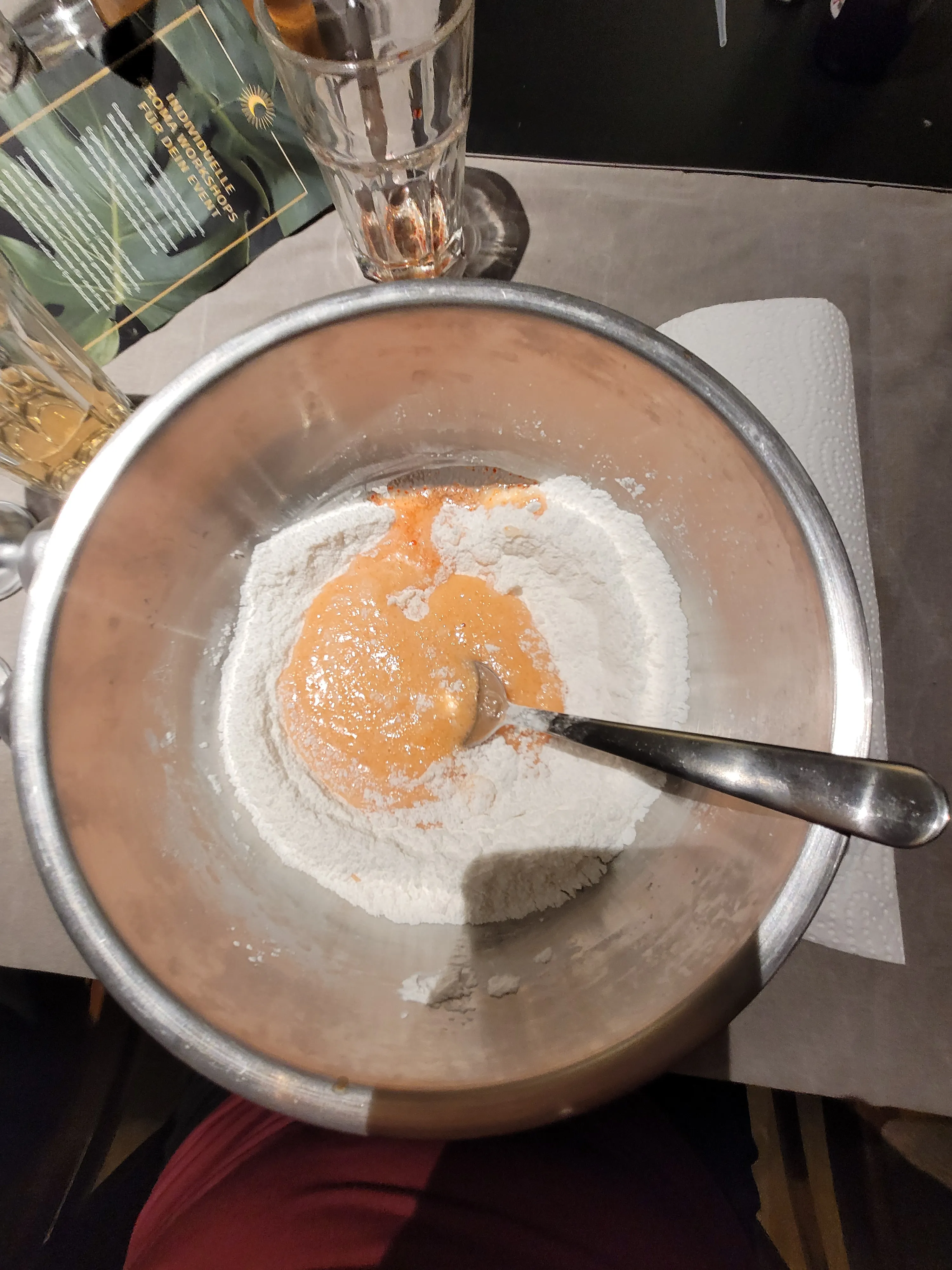 Bowl with flour and liquid mix, spoon inside.