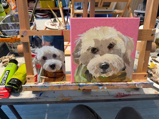 Dog photo and painting on easel.