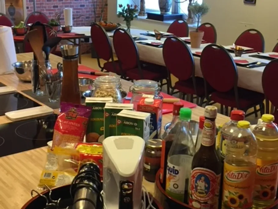 Kitchen with cooking utensils and drinks, ready to cook.