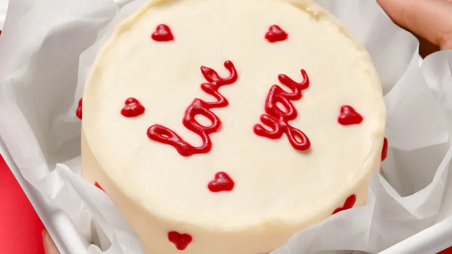 Cake with red hearts and icing text.