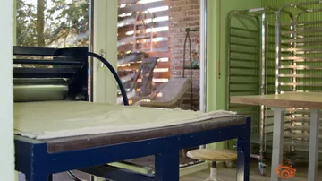 Printmaking press in a bright studio.