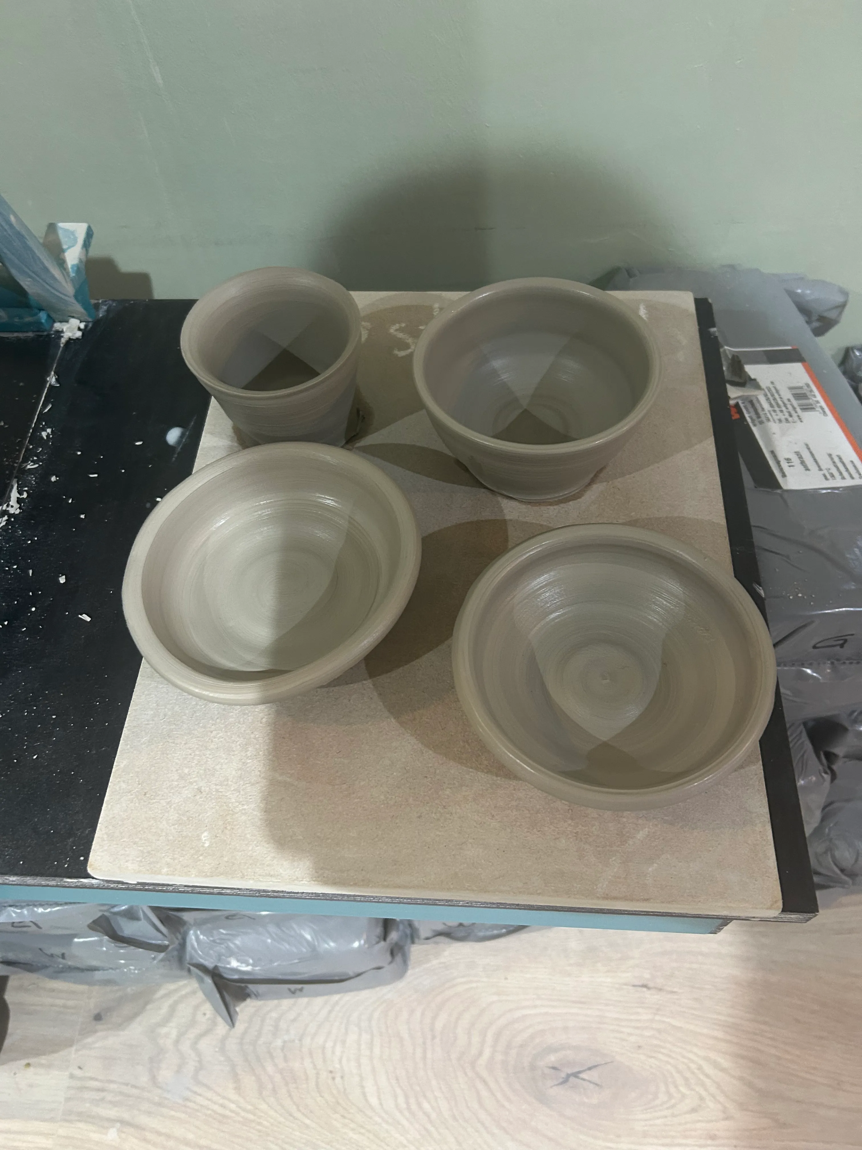 Four clay pots on a table top.