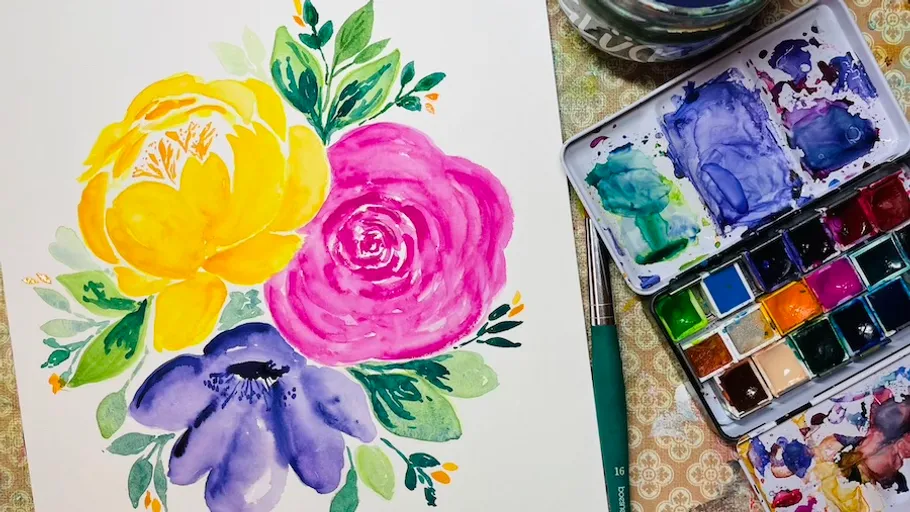 Colorful watercolor flowers with paints and brush.
