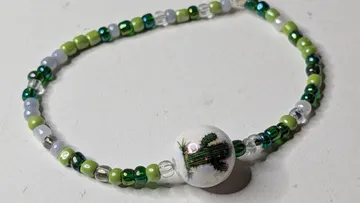 Beaded bracelet with cactus design centerpiece.