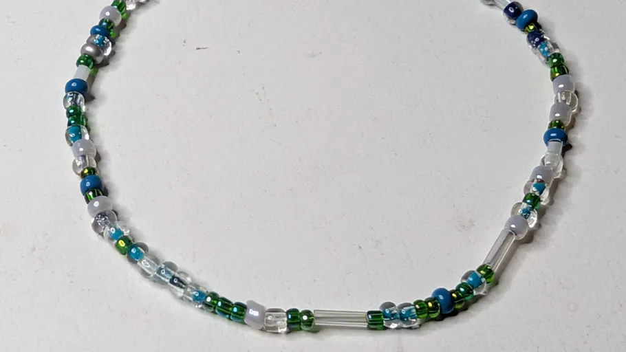 Colorful bead necklace on plain background.