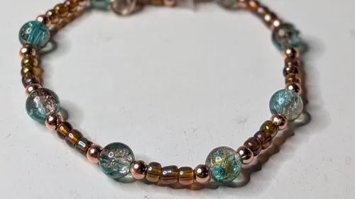 Beaded bracelet with glass and metallic beads.