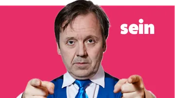 Man pointing on pink background.