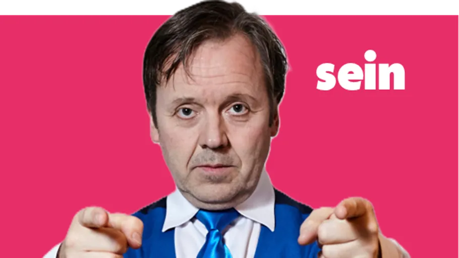 Man pointing on pink background.