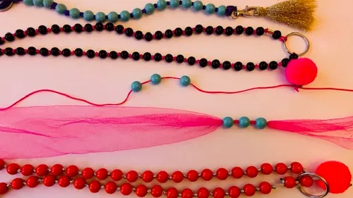 Colorful beaded necklaces on white background.