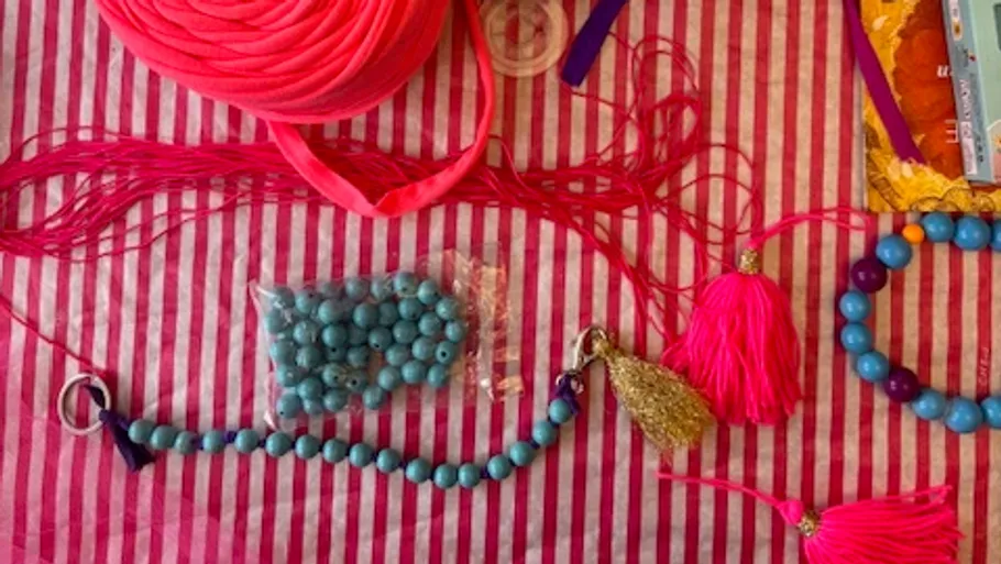 Craft materials on a striped surface.