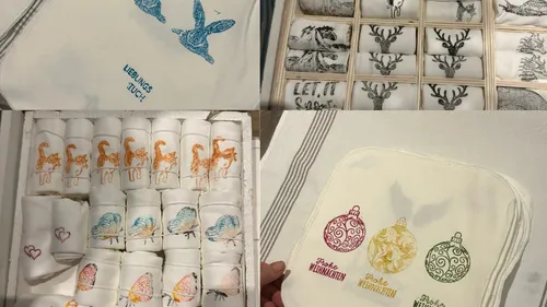 Cloth napkins with various designs and text.