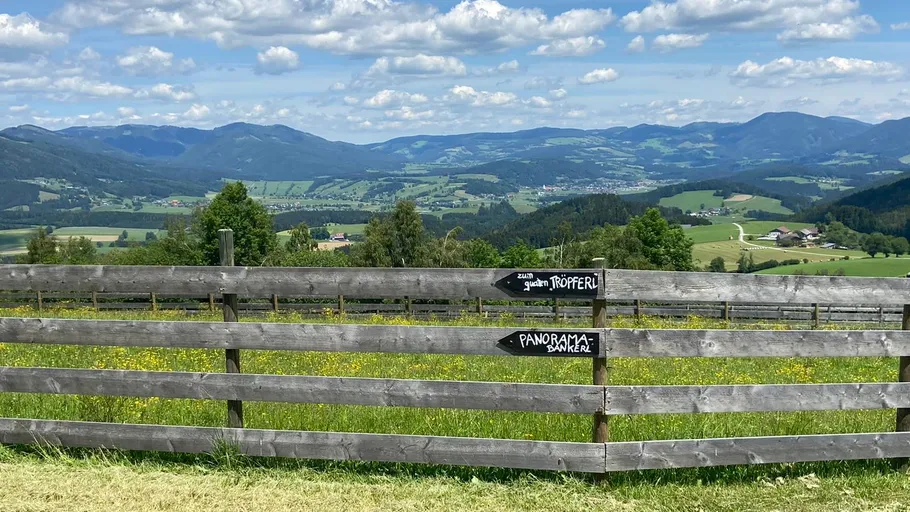 Mountains view with wooden fence foreground.