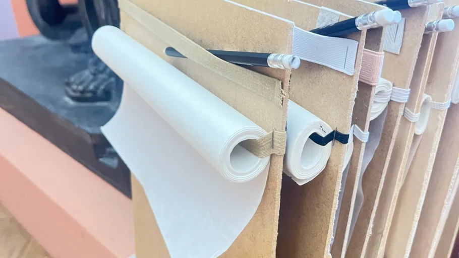 Rolled scrolls on wooden holders in museum.