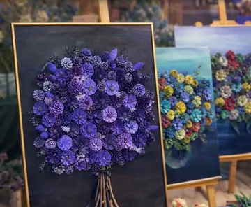 Colorful pine cone art displayed on easels.