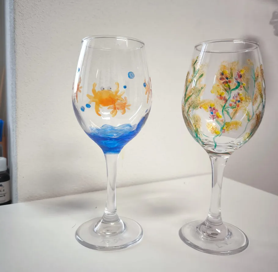 Two painted wine glasses on a table.