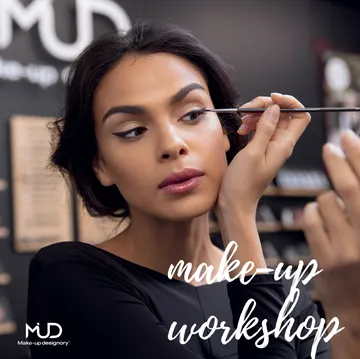 Woman applying makeup in beauty store.