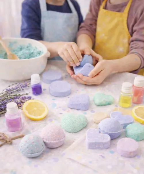 Two children making colorful bath bombs together.
