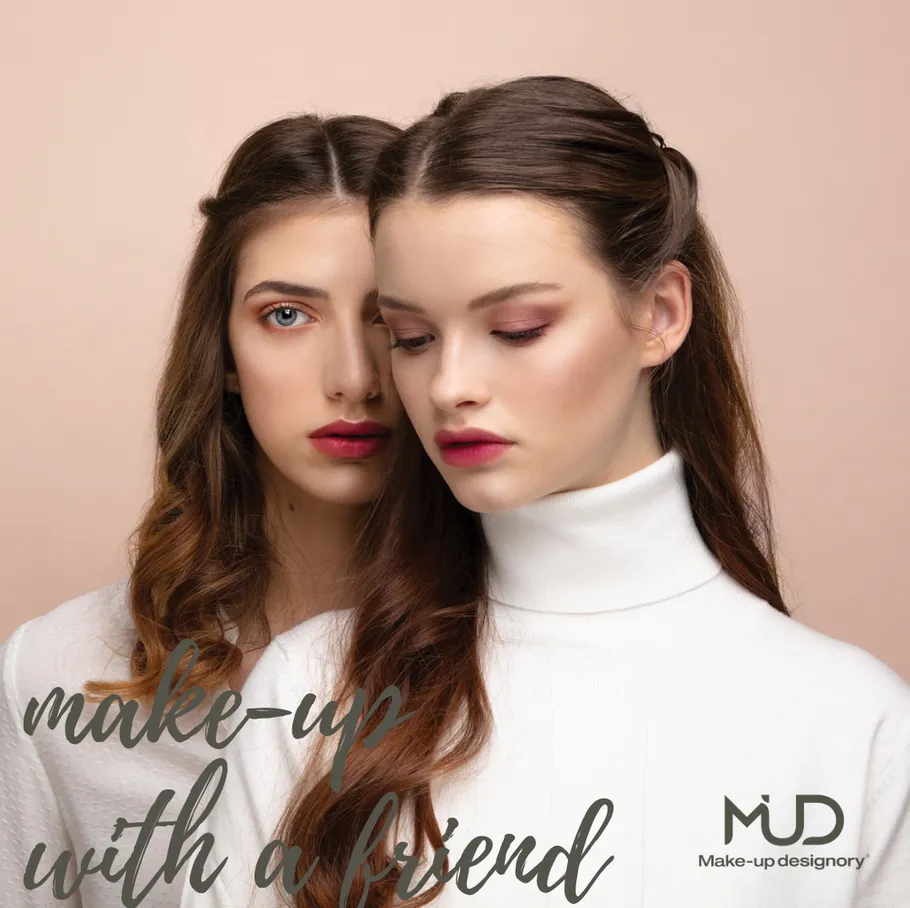 Two women with styled hair, neutral background.